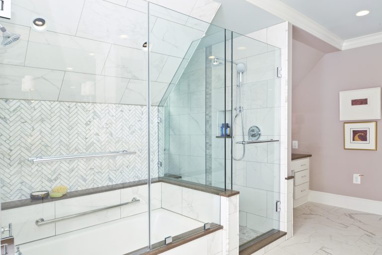 modern bathroom renovation separate tub and shower with glass door with storage and tile on slanted ceiling
