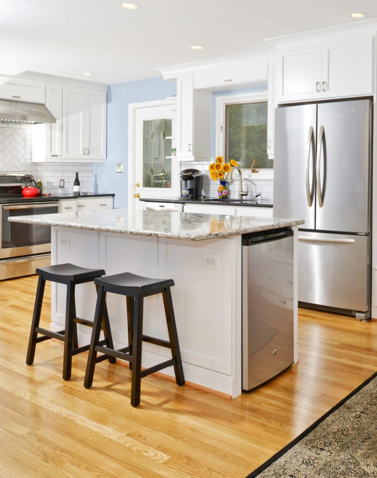 traditional kitchen light blue walls wood floors center island with seating