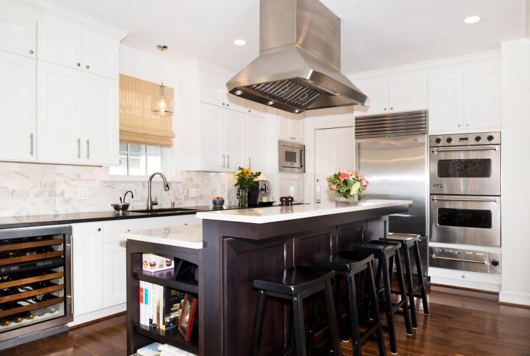 renovated kitchen island with bar seating stainless steel appliances double wall oven beverage fridge recessed lighting