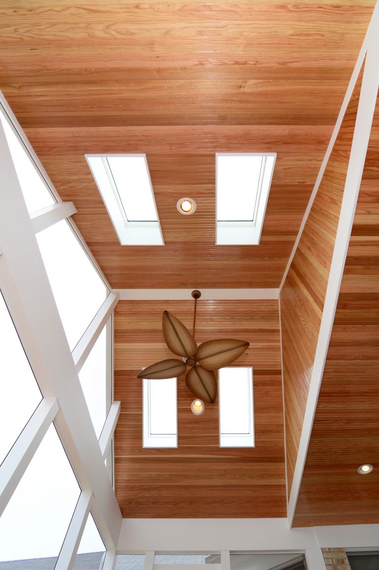 vaulted wood ceilings with skylights ceiling fan and recessed lighting