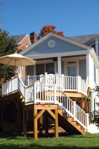 second story back deck addition on blue dc home with stairs to yard