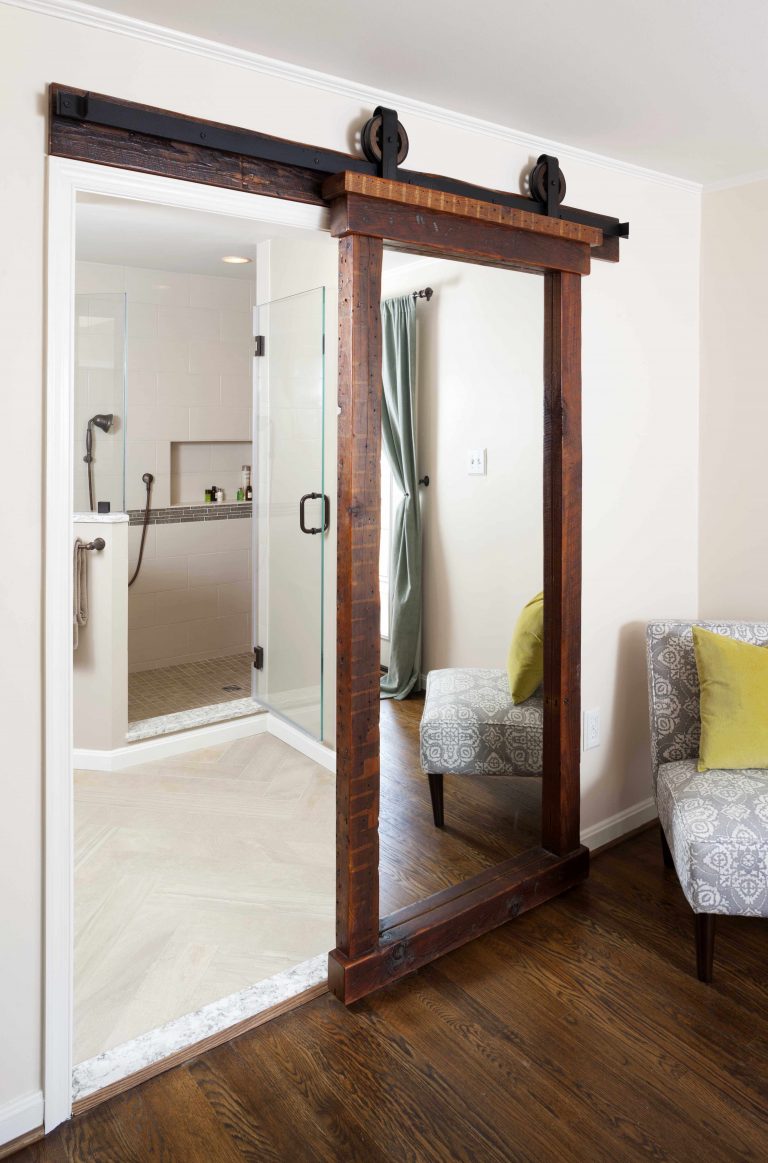 sliding frosted glass barn door in master bathroom