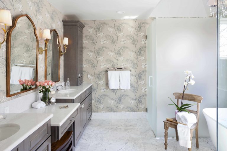 overview of renovated bathroom traditional style neutral color palette with gray toned cabinetry and floral wallpaper