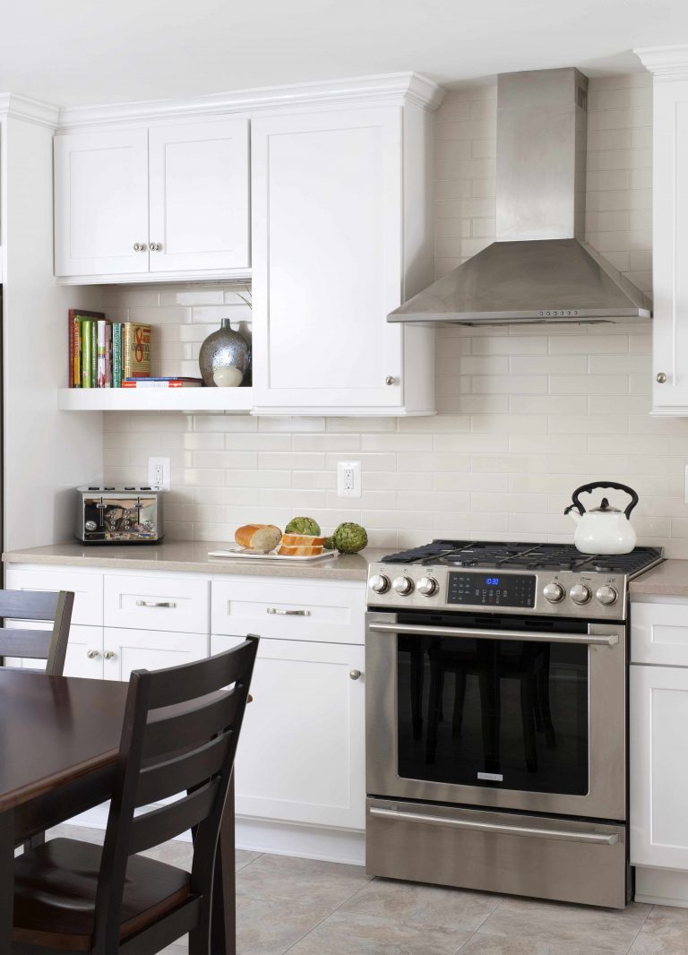 white kitchen stainless steel appliances with range hood unique cabinetry