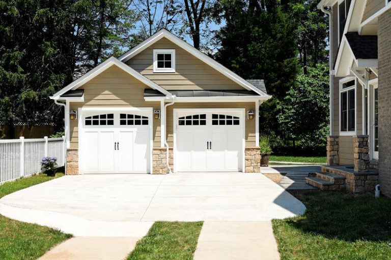 separate staggered double garage craftsman style with stone base beige neutral color palette