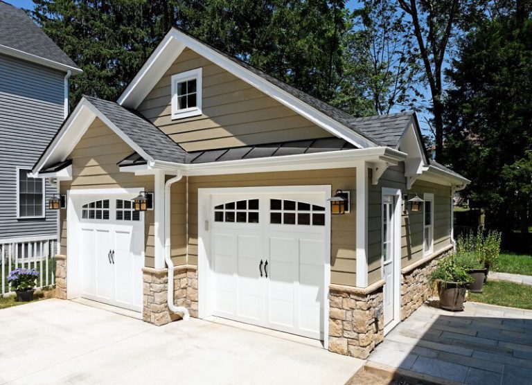 separate staggered double garage craftsman style with stone base beige neutral color palette