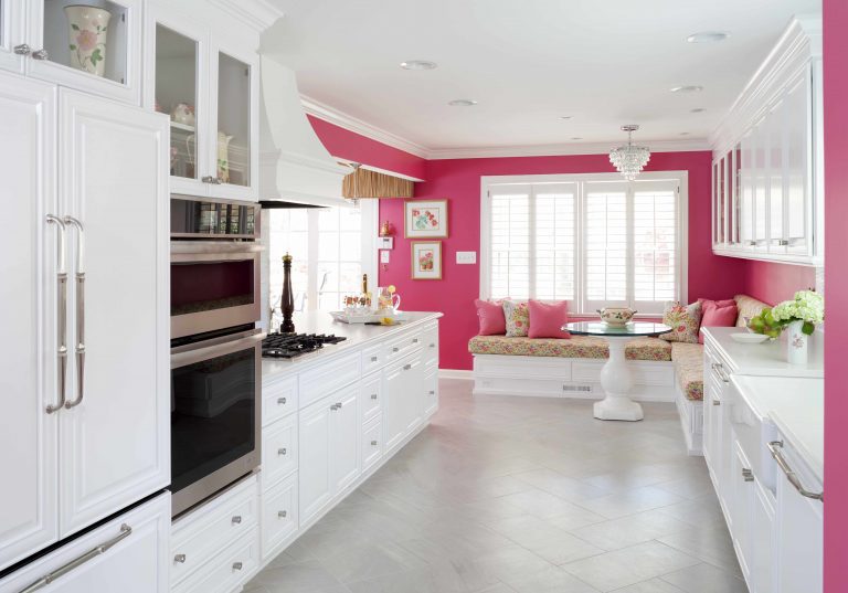 bright white kitchen with hot pink feature wall eat in area with banquette seating