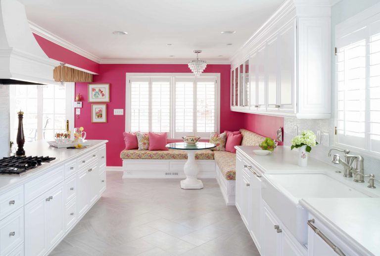 bright white kitchen with hot pink feature wall eat in area with banquette seating