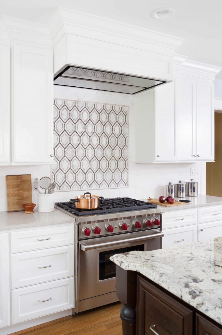 stainless steel gas range and range hood tile detail backsplash