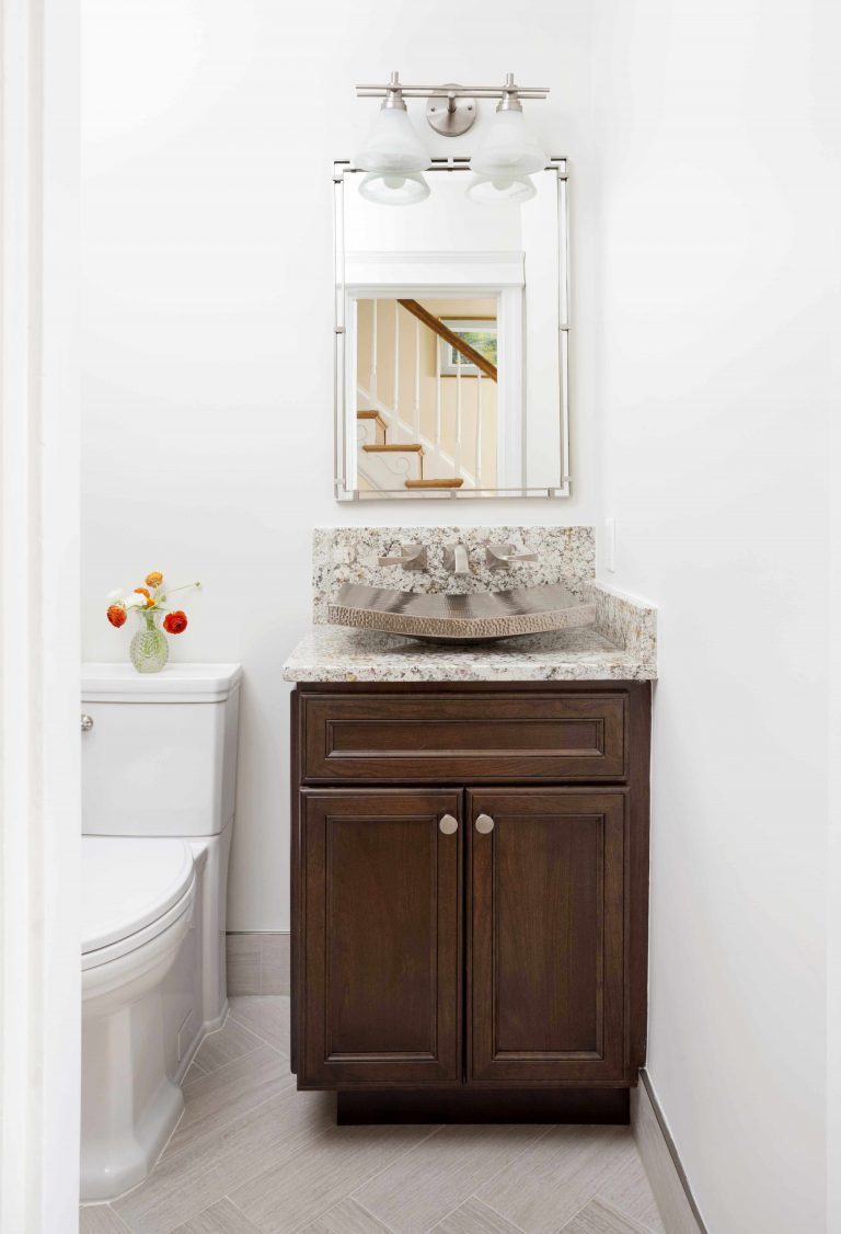 bright bathroom wood vanity with modern stone basin sink