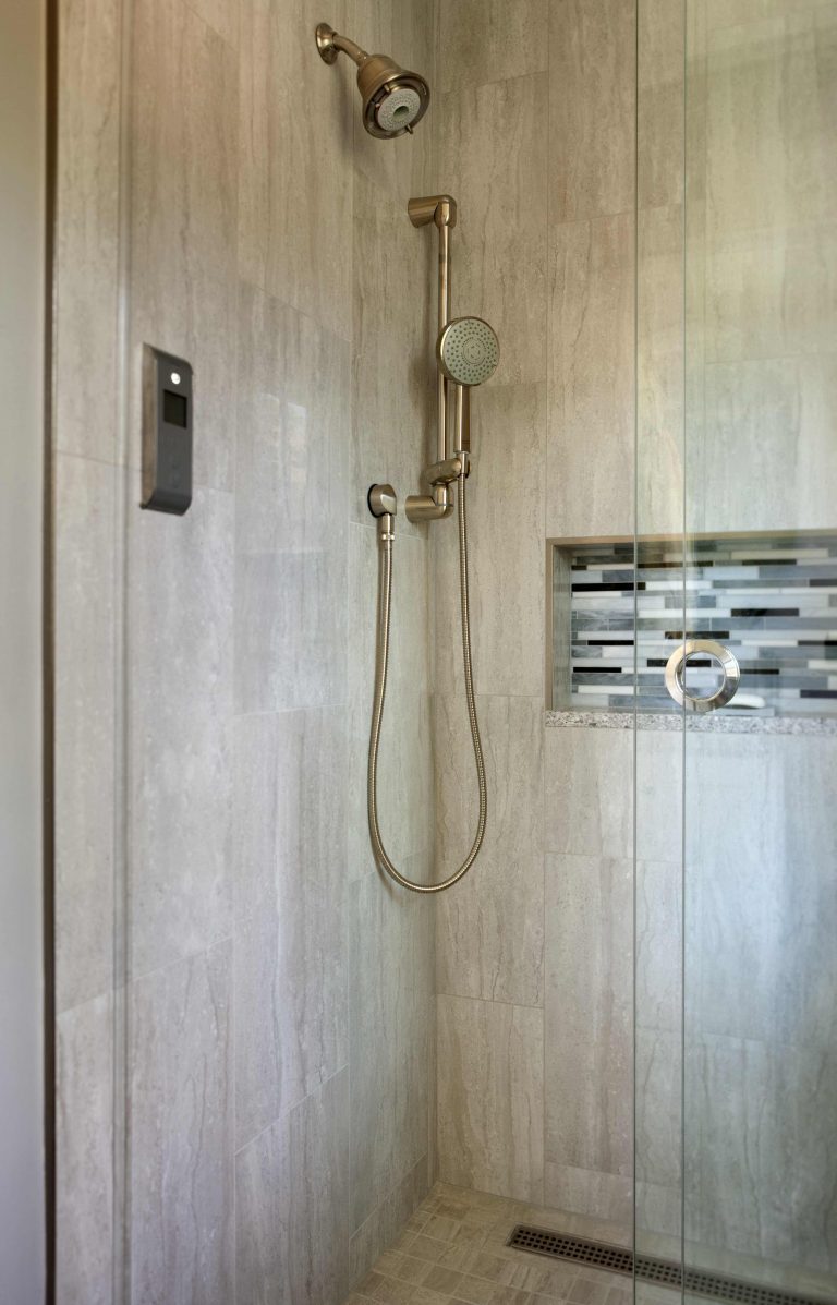bright bathroom glass shower built in storage nook tile feature