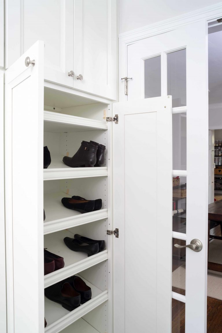 bright white mudroom in Maryland house with built-in shoe storage