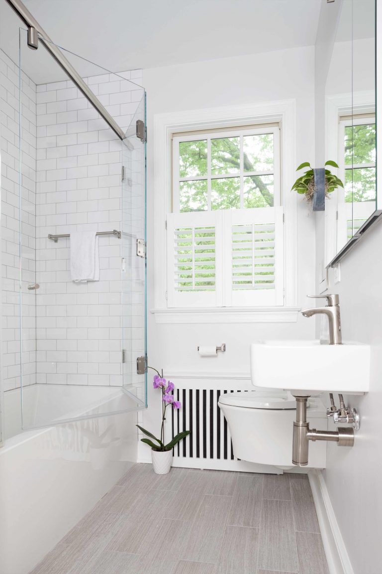 bright white sleek bathroom in dc home floating toilet and sink with exposed pipes