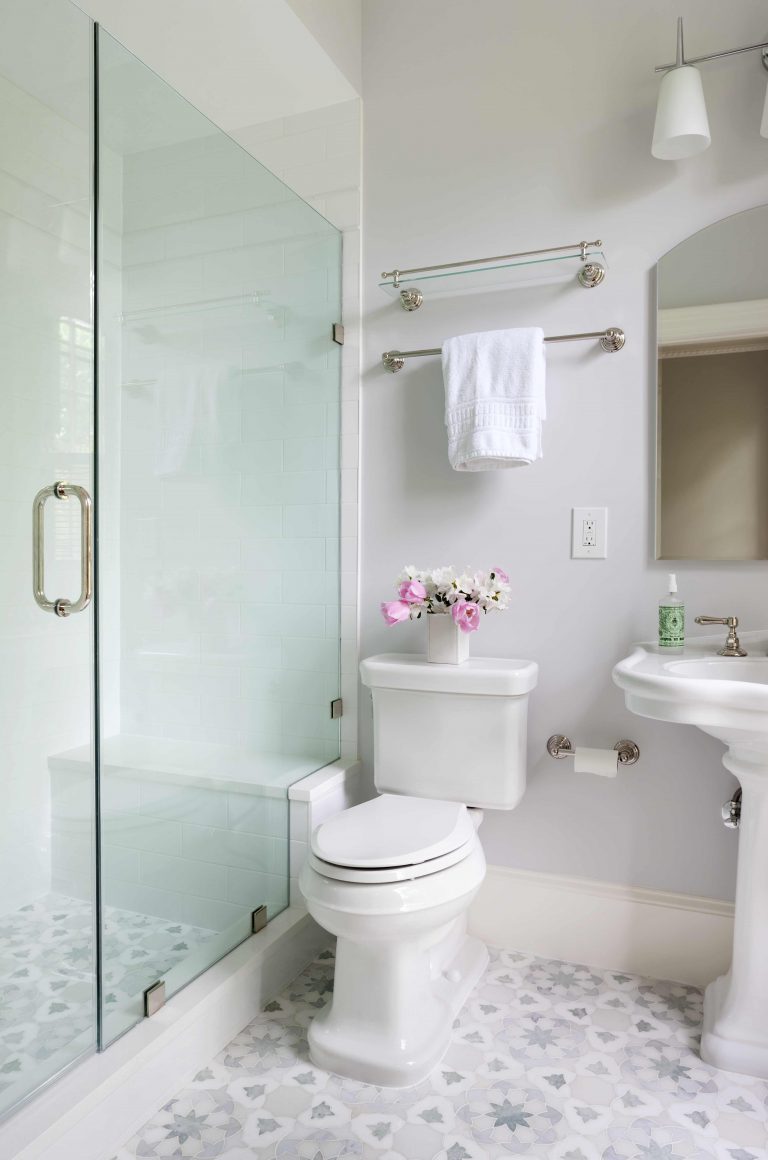 neutral color palette bathroom shower with glass door geometric mosaic tile floor design
