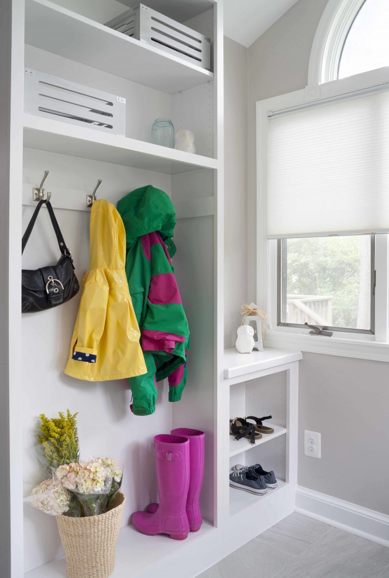 mudroom entry area with storage and hooks