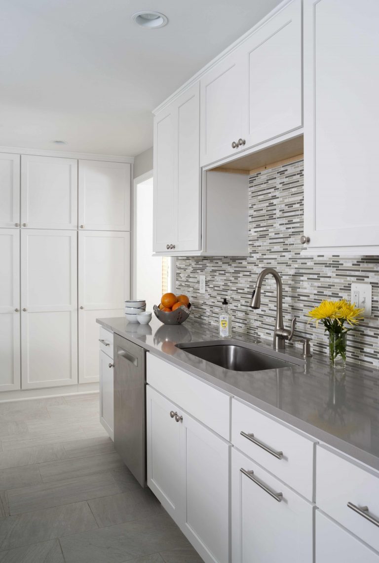 white and gray modern kitchen mosaic tile backsplash stainless steel appliances