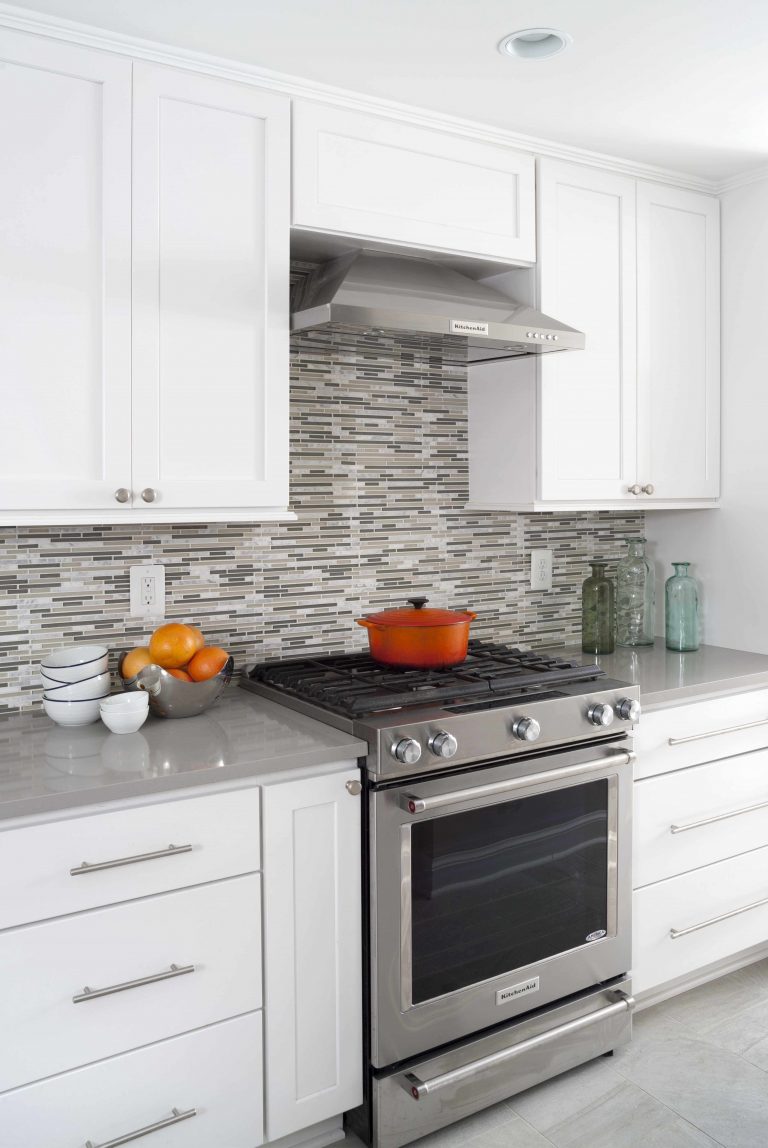 white and gray modern kitchen mosaic tile backsplash stainless steel appliances