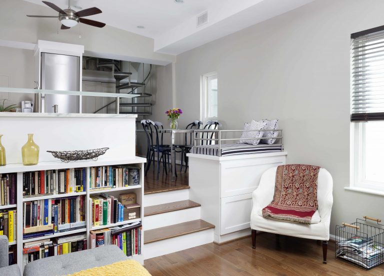 open split-level floorplan living room and kitchen built-in bookshelves