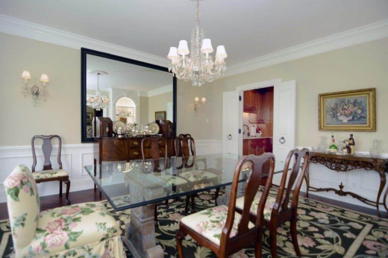traditional dining room in dc home glass table with antique chairs chandelier and crown molding