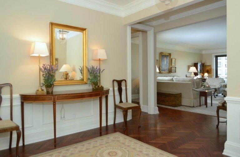 bright hallway with chevron dark wood floors white crown molding and wainscoting