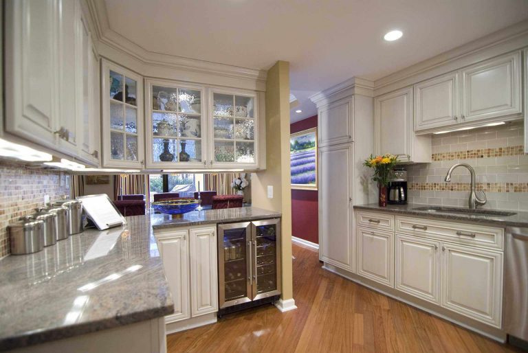 traditional style kitchen in dc home warm color palette white cabinets with glass door uppers wood floors beverage refrigerator