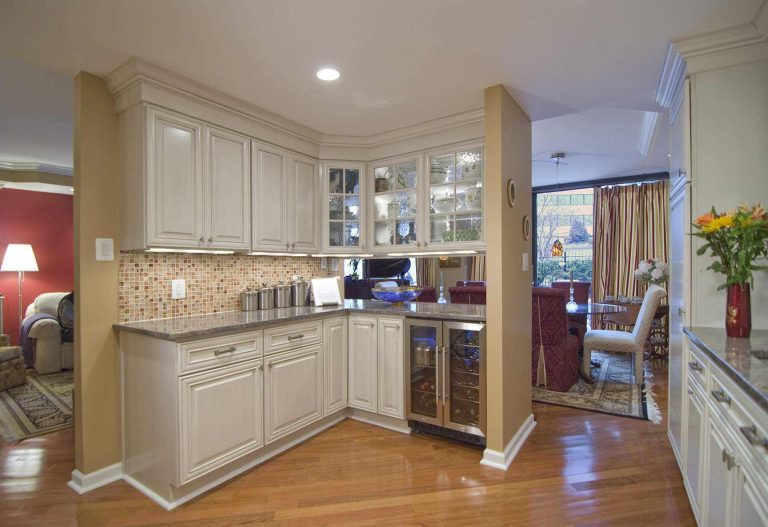 traditional style kitchen in dc home warm color palette white cabinets with glass door uppers wood floors beverage refrigerator