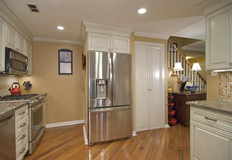 traditional style kitchen in dc home warm color palette white cabinets wood floors stainless steel appliances