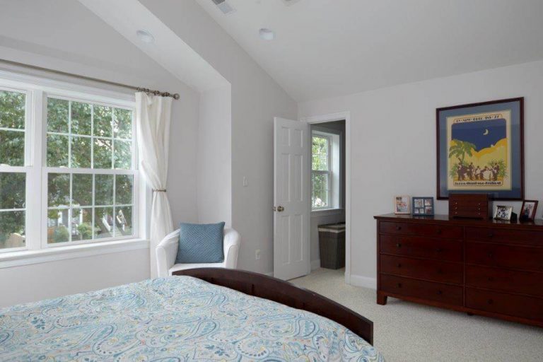 renovated master bedroom large window calm white color palette