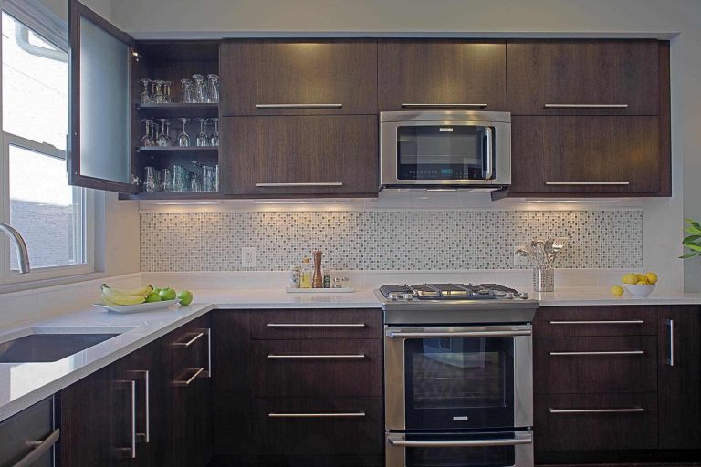 modern kitchen design dark wood cabinets one upper with frosted glass door stainless steel appliances mosaic tile backsplash detail
