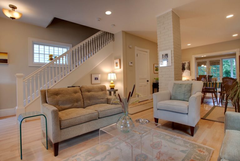 renovated living area in dc home light color palette exposed brick column