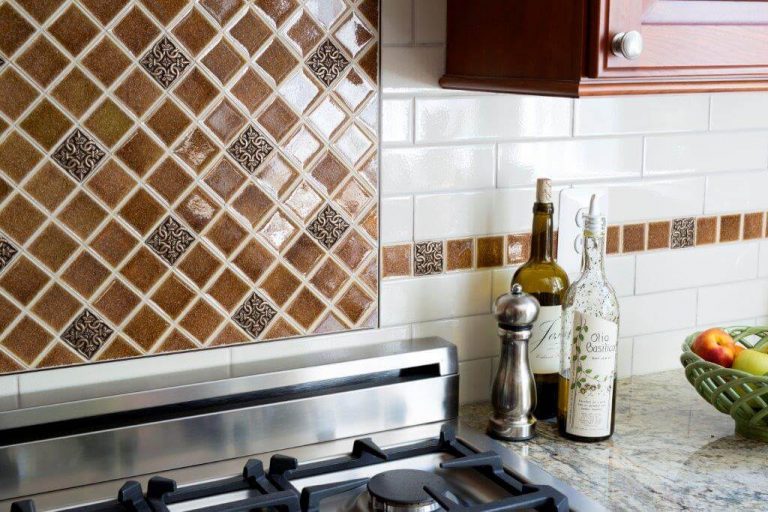 tile backsplash detail white subway tiles with brown and orange tone mosaic