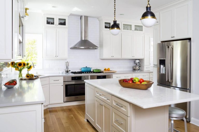 bright kitchen cream cabinetry center island with pendant lighting stainless steel appliances