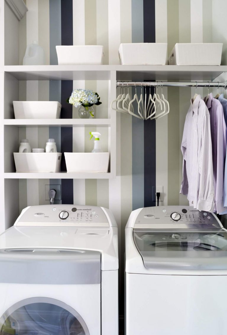 renovated laundry area with striped wallpaper open shelving green and neutral tone color palette