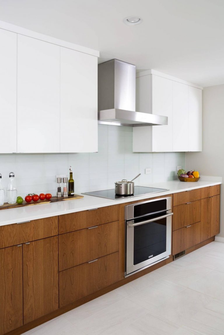 stainless steel electric range and hood in modern kitchen sleek design
