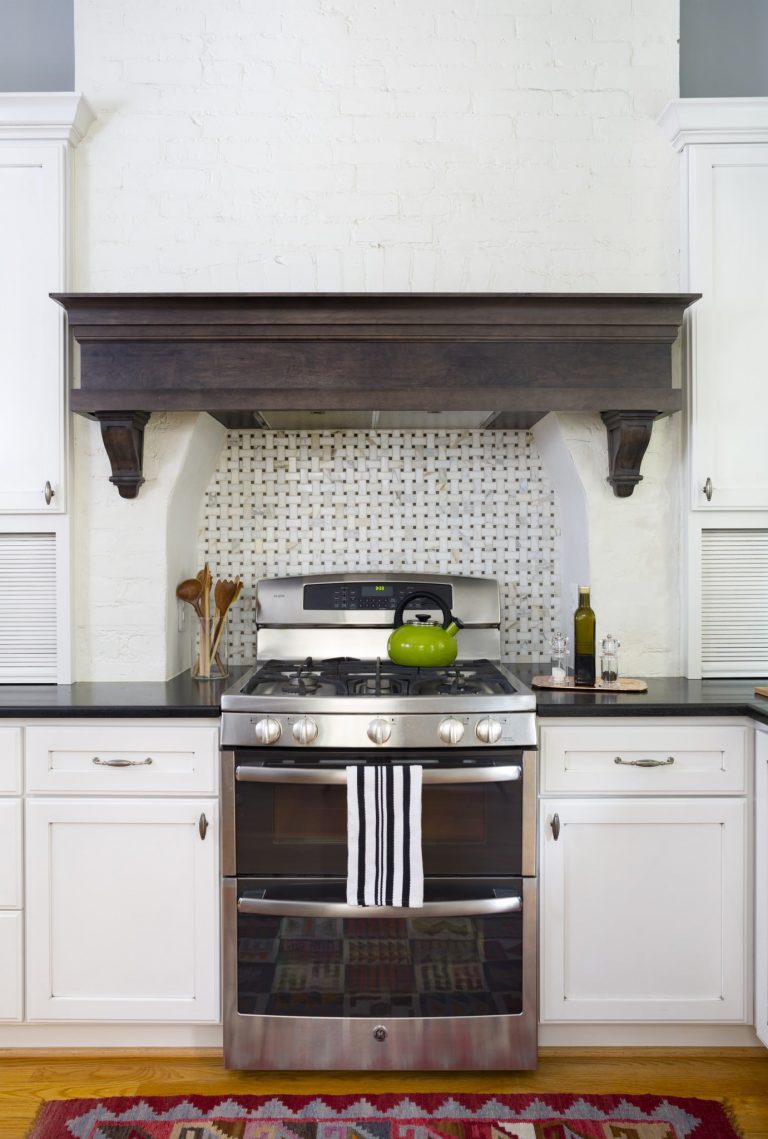 DC rowhouse kitchen with character white cabinets contrast black range hood