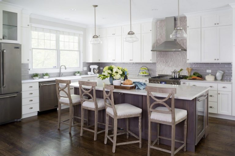 kitchen with neutral and gray color palette white upper cabinets center island with seating and pendant lighting above