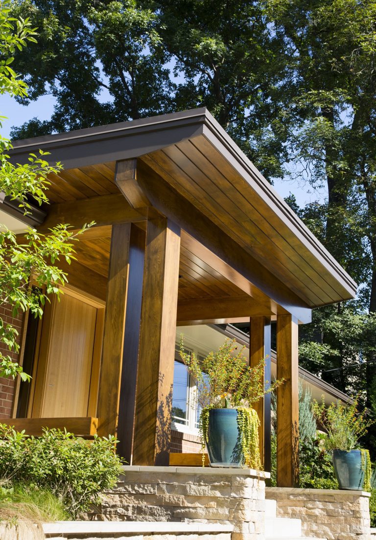 modern brick home new front porch with wood columns and overhang stone foundation mixed materials