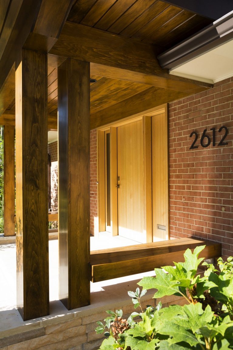 modern brick home new front porch with wood columns and overhang mixed materials