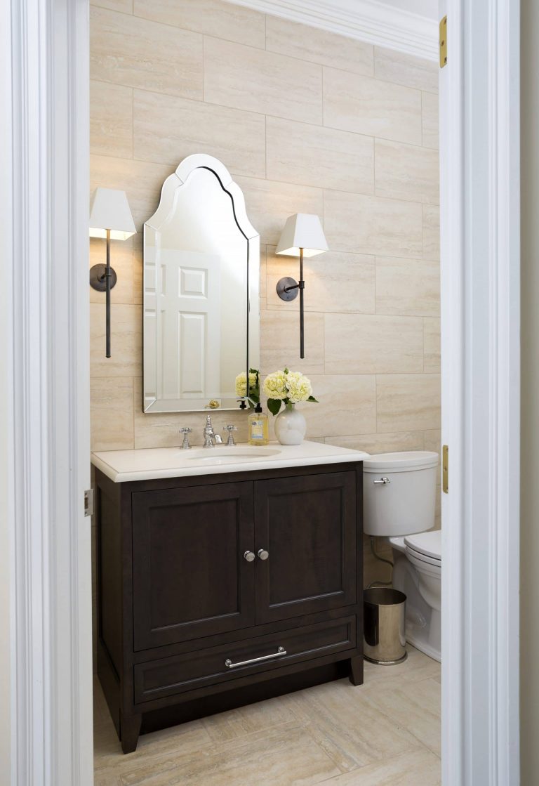 traditional bathroom dark wood vanity neutral color palette sconce lighting