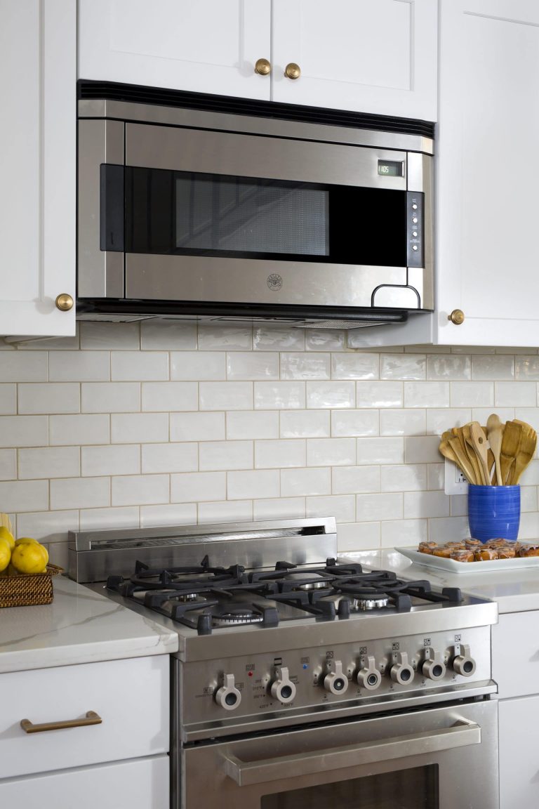 kitchen with white cabinetry and subway tile backsplash stainless steel appliances