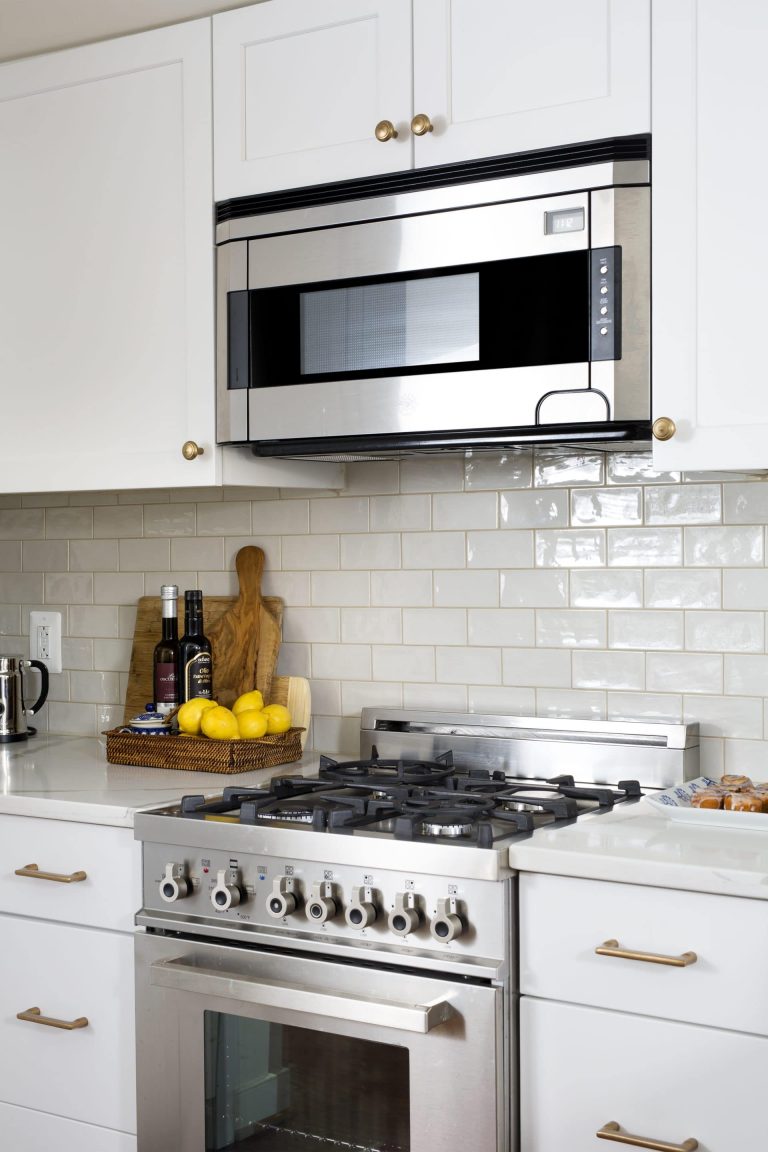 kitchen with white cabinetry and subway tile backsplash stainless steel appliances