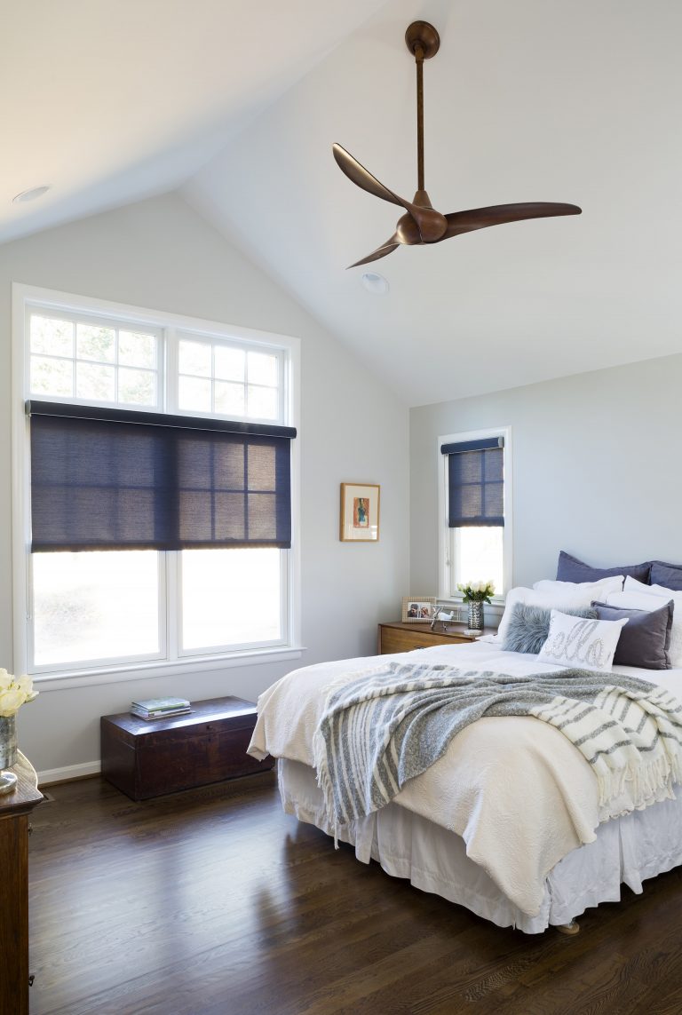 relaxing bedroom remodel gray and navy blue angled ceiling dark wood floors