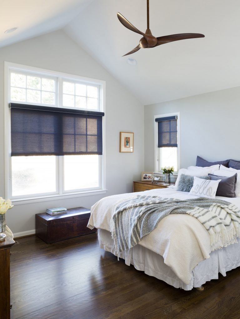 relaxing bedroom remodel gray and navy blue angled ceiling dark wood floors