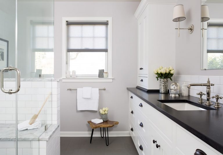 black and white bathroom with plenty of storage separate shower stall with glass walls and built in bench