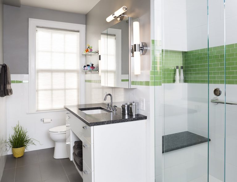 sleek modern bathroom black and white with pop of color shower stall with glass door built in bench and storage nook