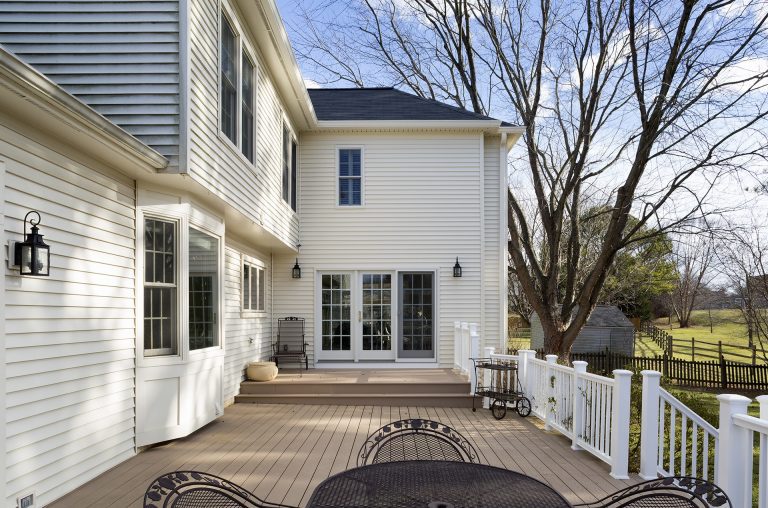 sliding glass doors lead to large multi-level back deck addition to Maryland home