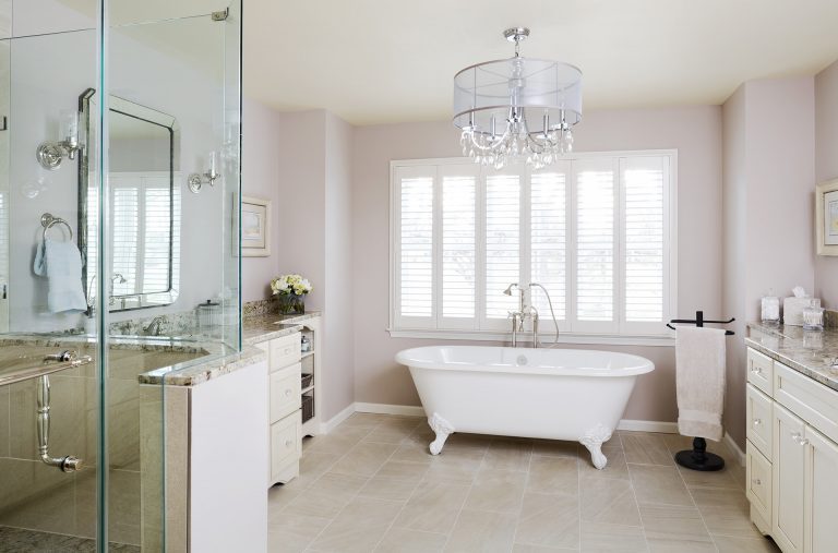 neutral color palette elegant master bathroom with large window separate tub and shower chandelier 2 sink vanities