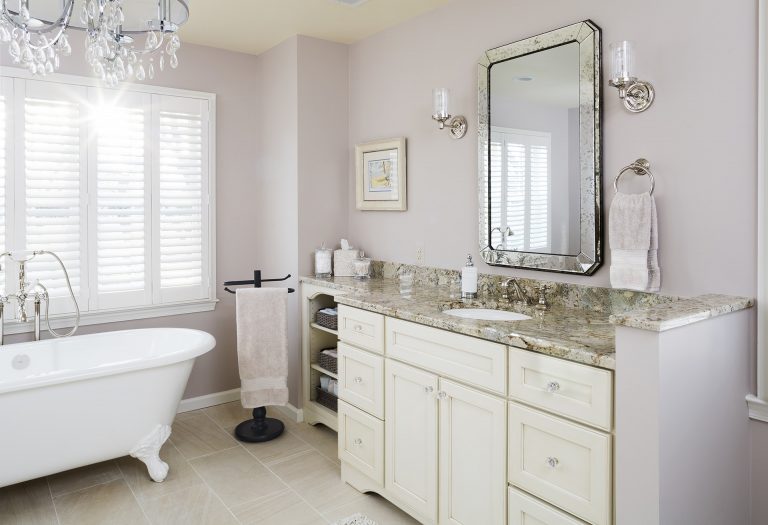 neutral color palette master bathroom with plenty of storage open shelving sconce lighting freestanding tub