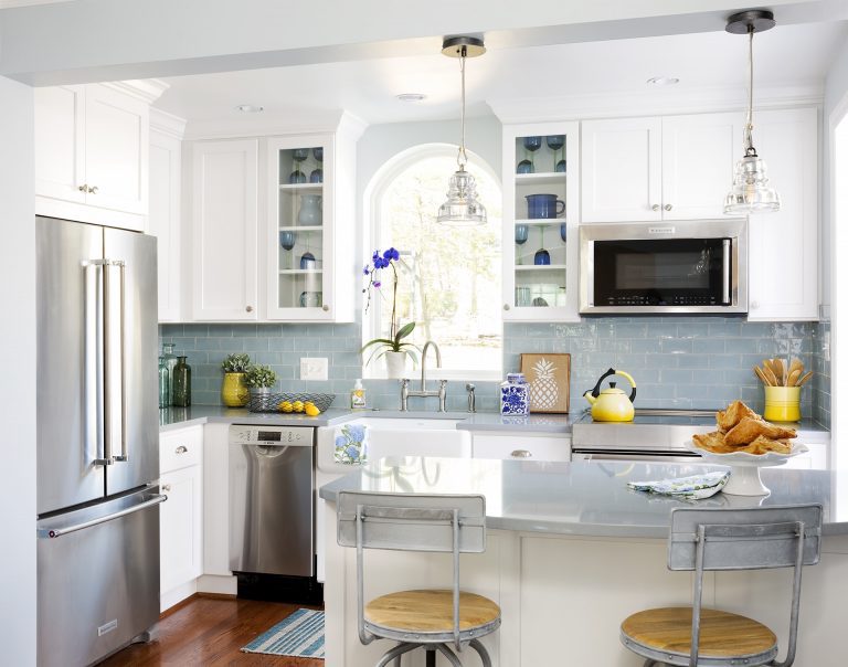 traditional farmhouse kitchen light blue and wood floors peninsula stainless steel appliances