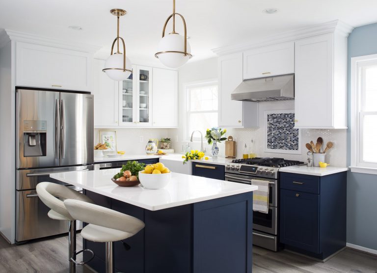 navy white and gold kitchen center island with seating and pendant lighting